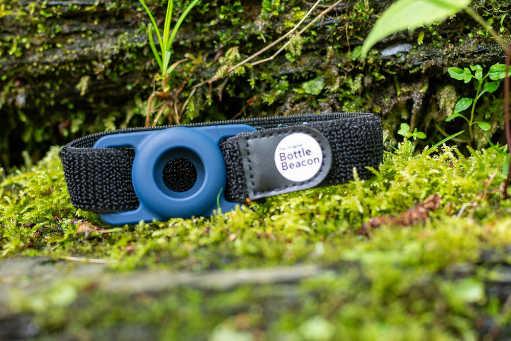 Dark blue Bottle Beacon strap resting on moss